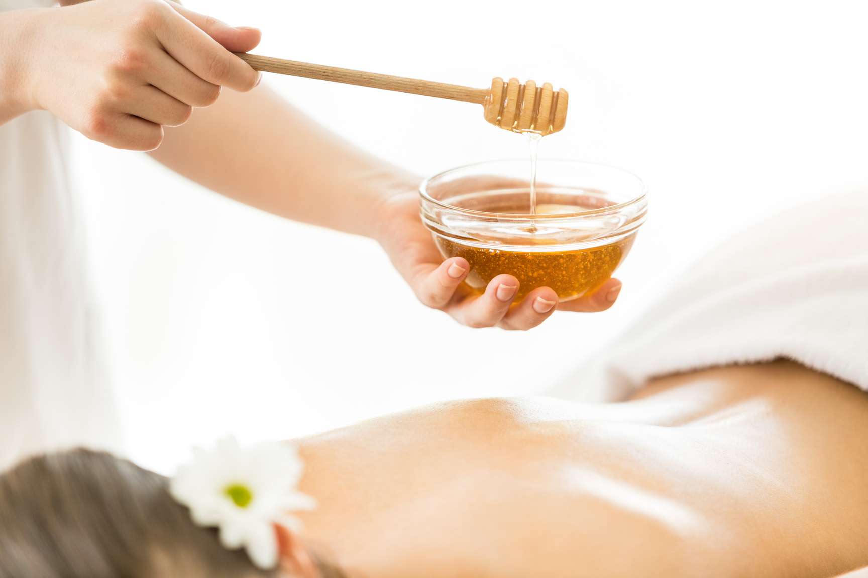 Woman having massage with honey